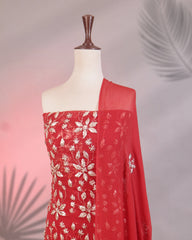 Red fabric with floral patterns draped over a mannequin against a gradient background