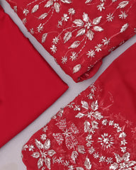 Red fabric with white floral patterns on a white background