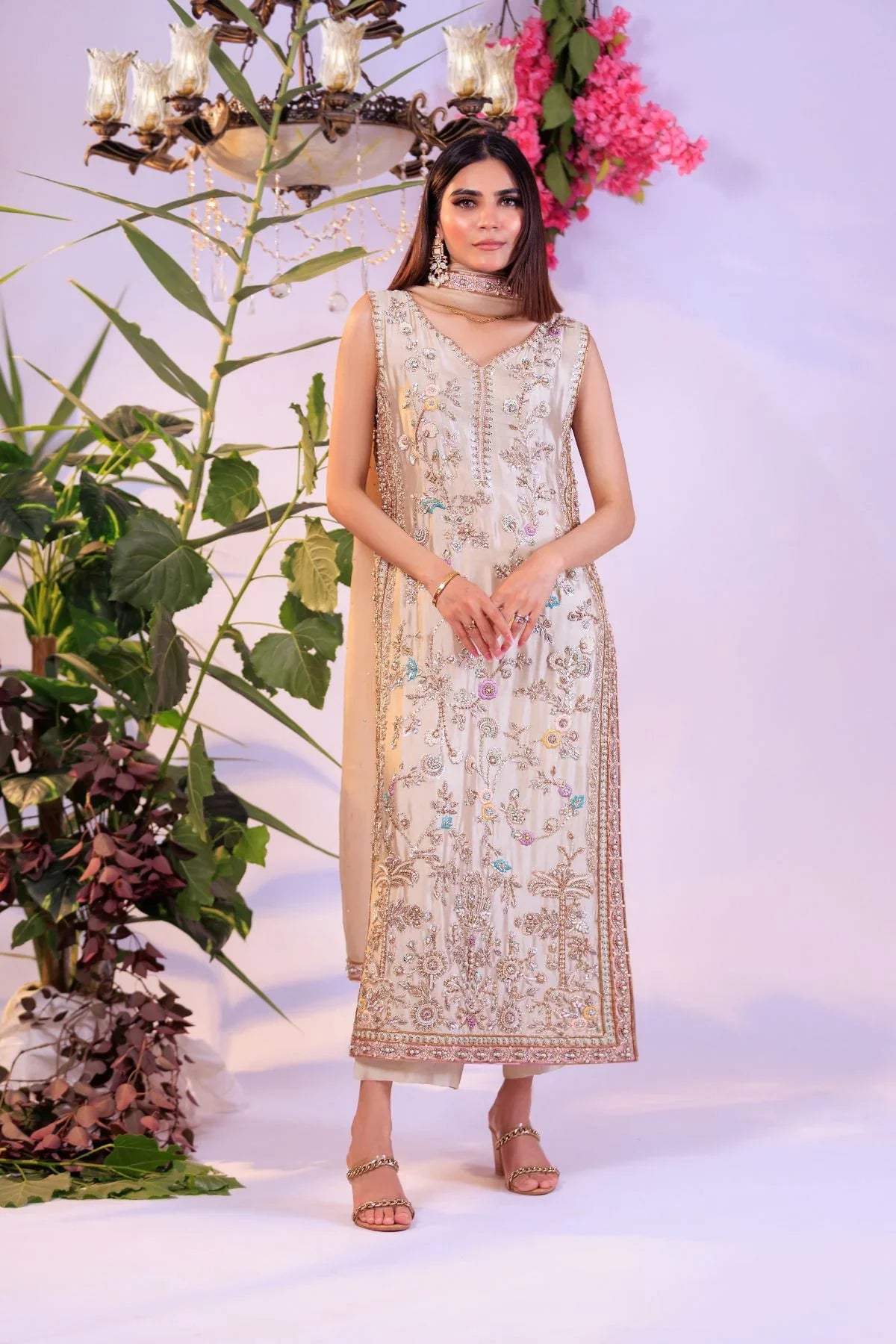 Front view of Ivory Blossom ivory festive dress with gold and pastel floral embroidery by Bazzaz.