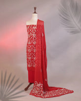 Red saree with white floral embroidery on a mannequin against a neutral background