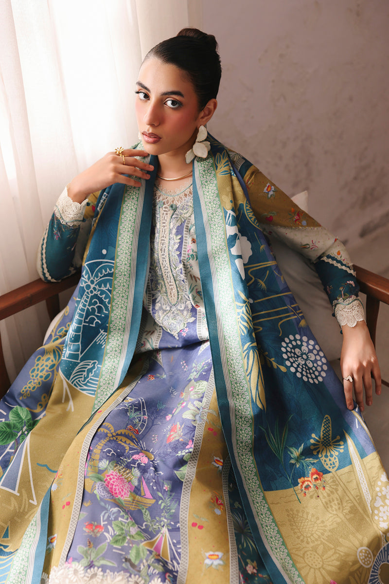 Woman wearing a colorful embroidered outfit sitting on a chair.