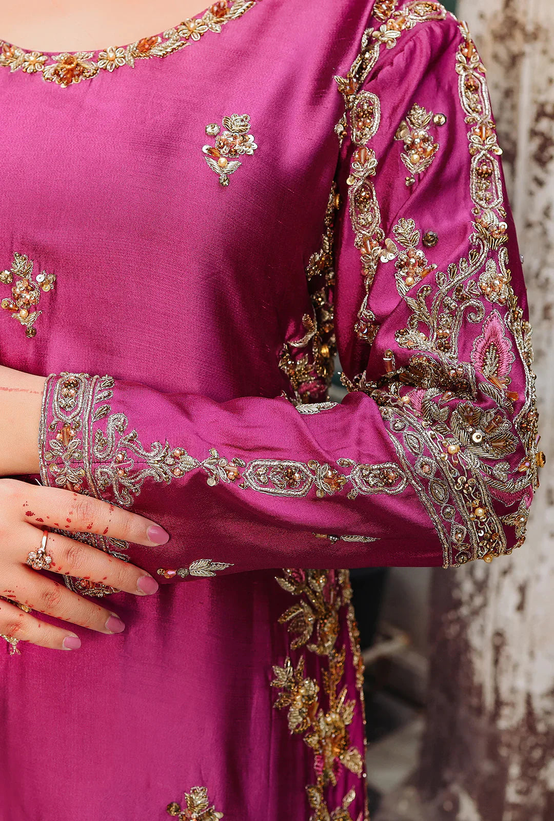 Closeup of dabka and nakshi hand embroidery on Gul-Rukh magenta bridal gown