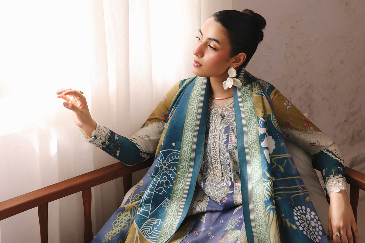 Woman wearing a patterned outfit sitting on a chair with a neutral background